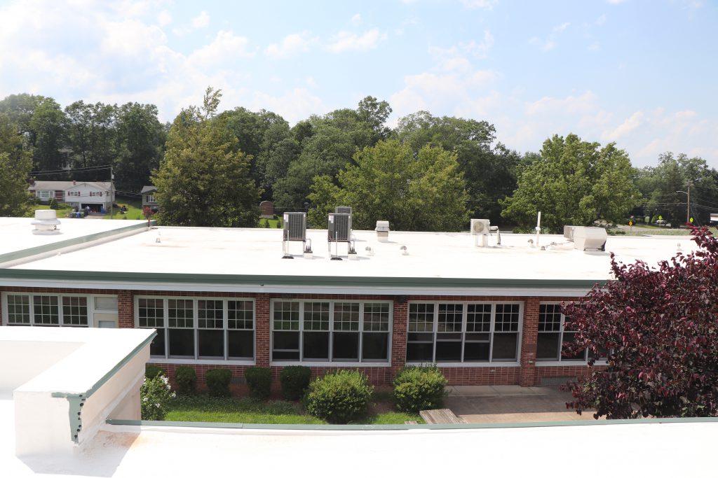 Image of the white roof of a school.