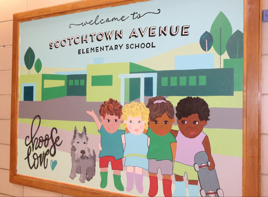 Bulletin board painting of Scotchtown Avenue Elementary School and four children.