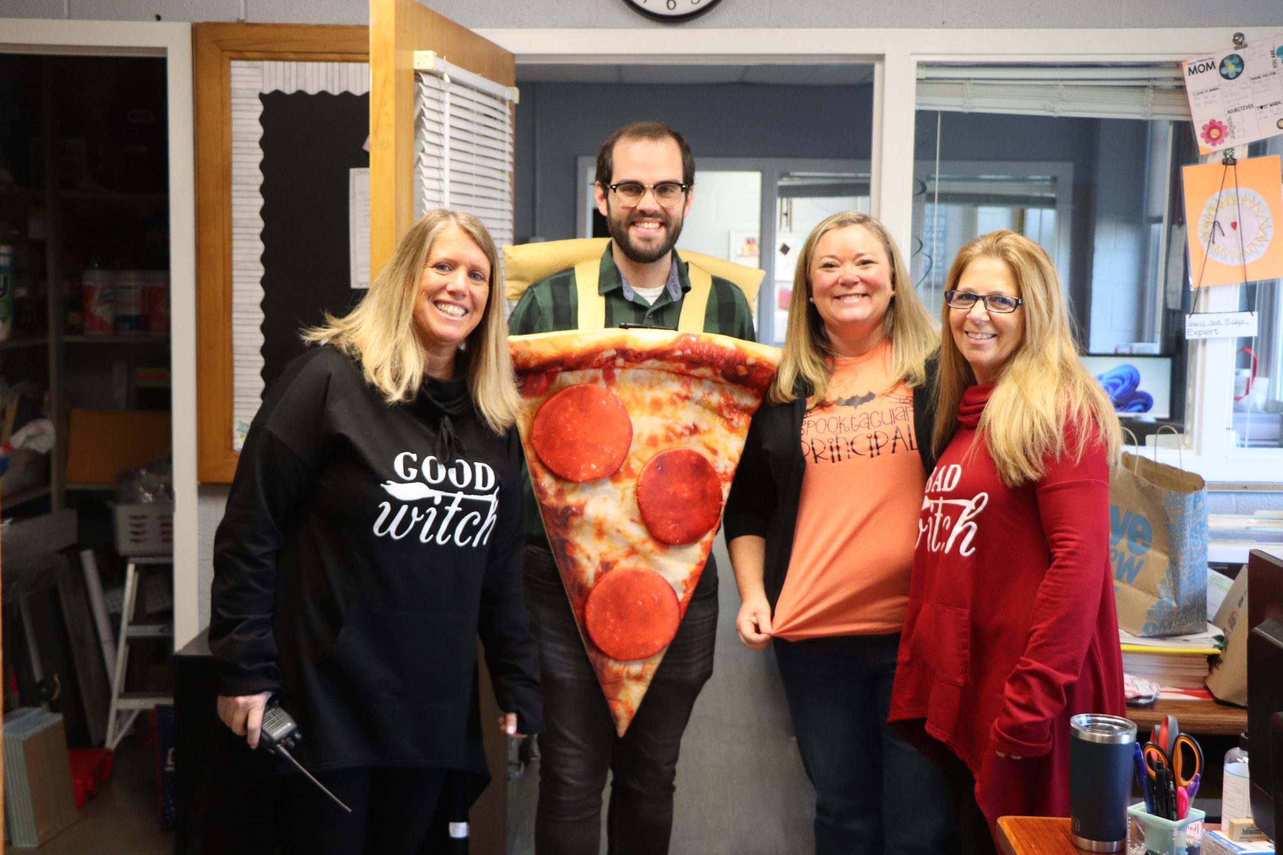 The Scotchtown Avenue Elementary School principal, faculty and staff joined in on costume fun for Halloween, with shirts that say "Spooktacular Principal," "Good Witch," "Bad Witch," and a pizza slice costume.