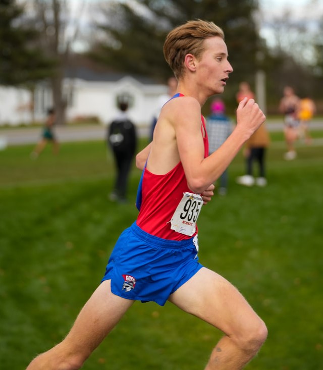 A Goshen high school student runs at a state cross country meet.