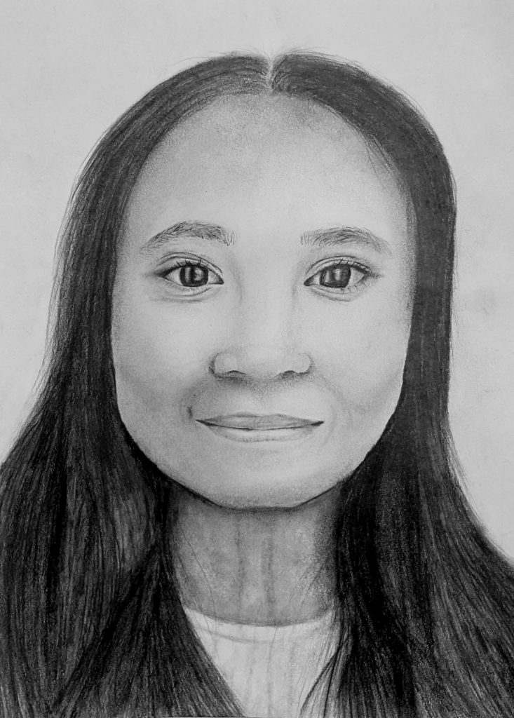 A drawing of a self portrait of a girl with long dark hair parted in the middle and a smile that makes her eyes sparkle.