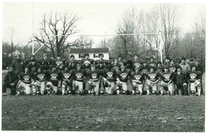 A black-and-white photo of the 1972 Goshen Football team posing together on the field.