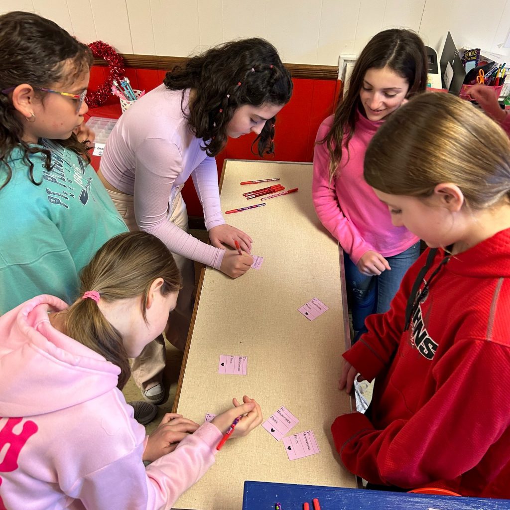 Middle school students write Valentine's Day grams. 