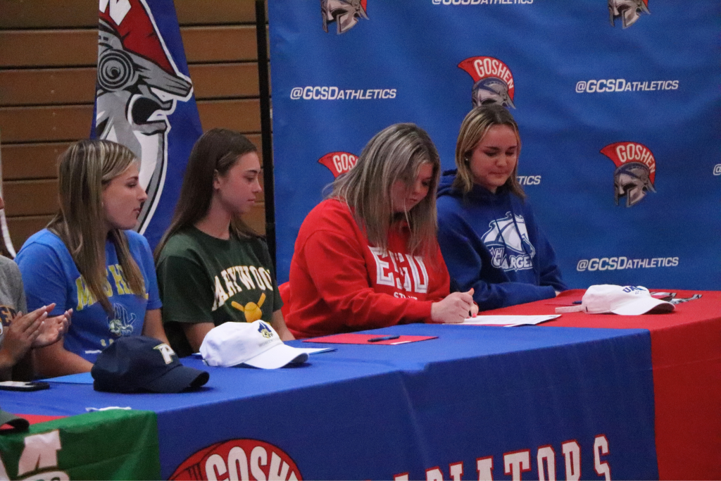 Hope Miller signs a letter to make official her attendance to East Stroudsburg University.