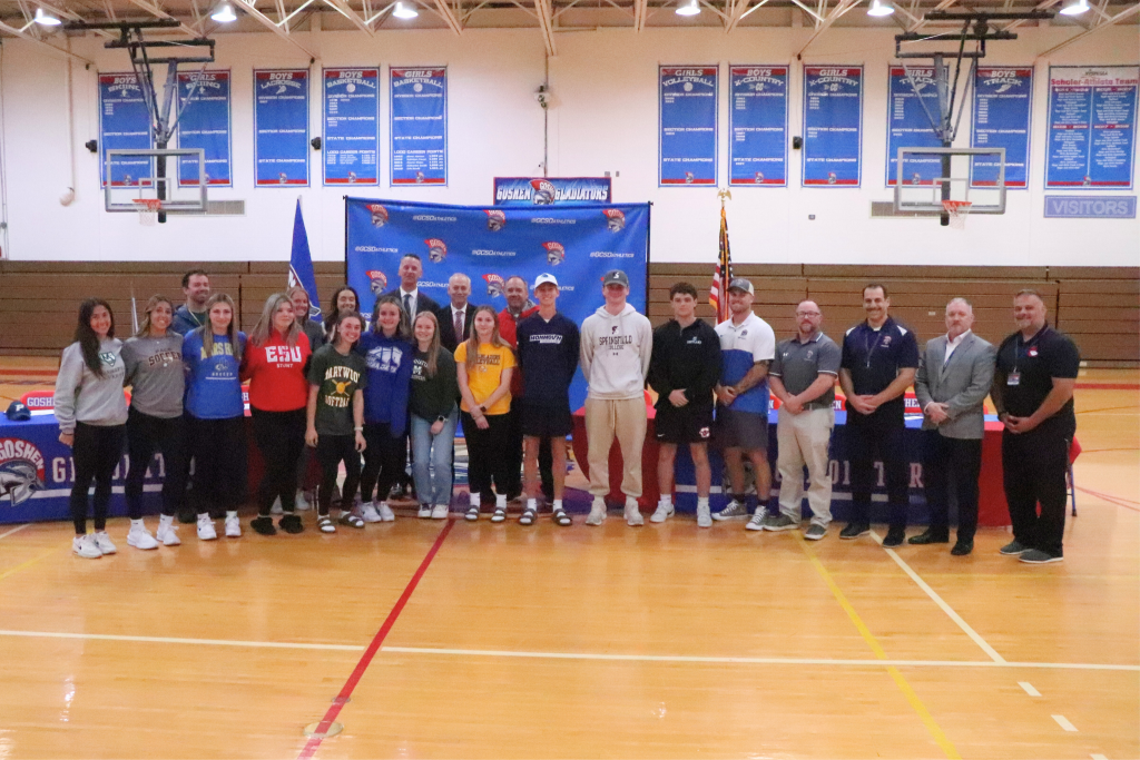 A group photo of all the athletes going to play college athletics with Goshen's Superintendent, High School Principal and assistant Principal, and Goshen's athletic director.