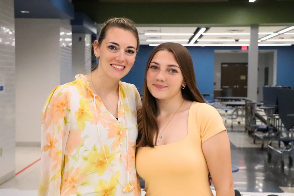 A teacher and a student smile for the camera at the Goshen Greats breakfast.