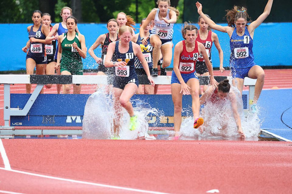 Isabel Barnhorst lands in the water at the 2000meter steeplechase.