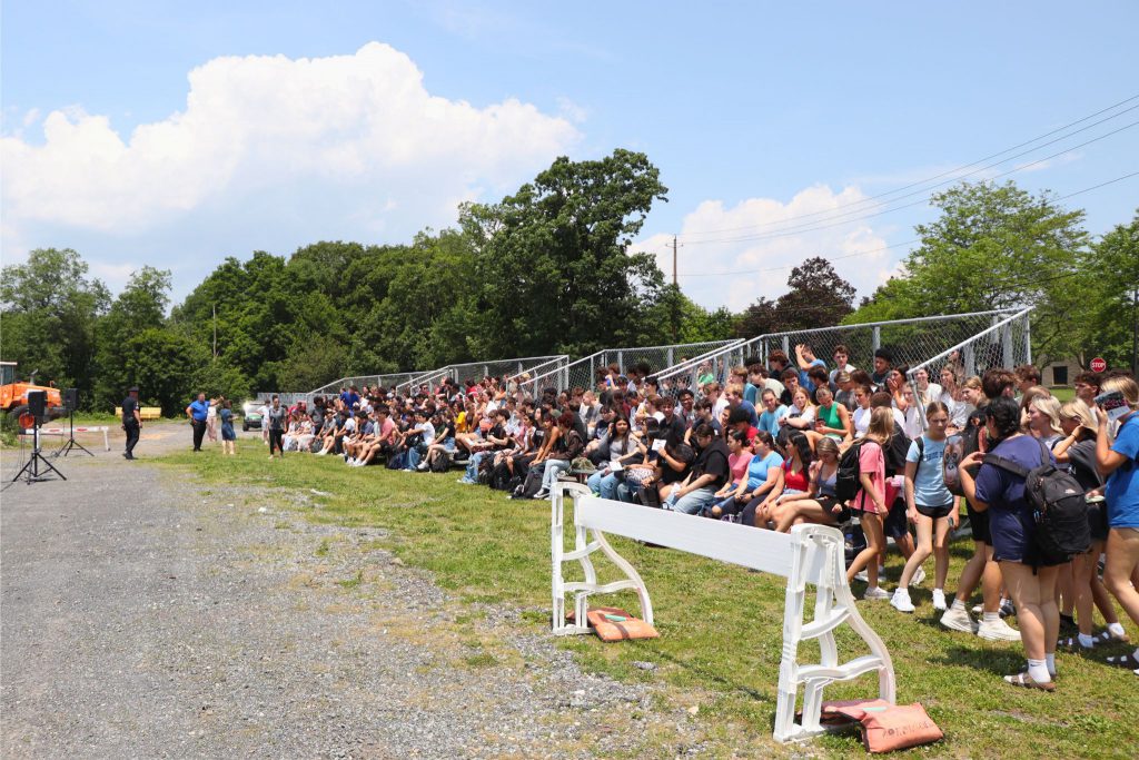 Students sitting in bleachers to watch the mock crash simulation.