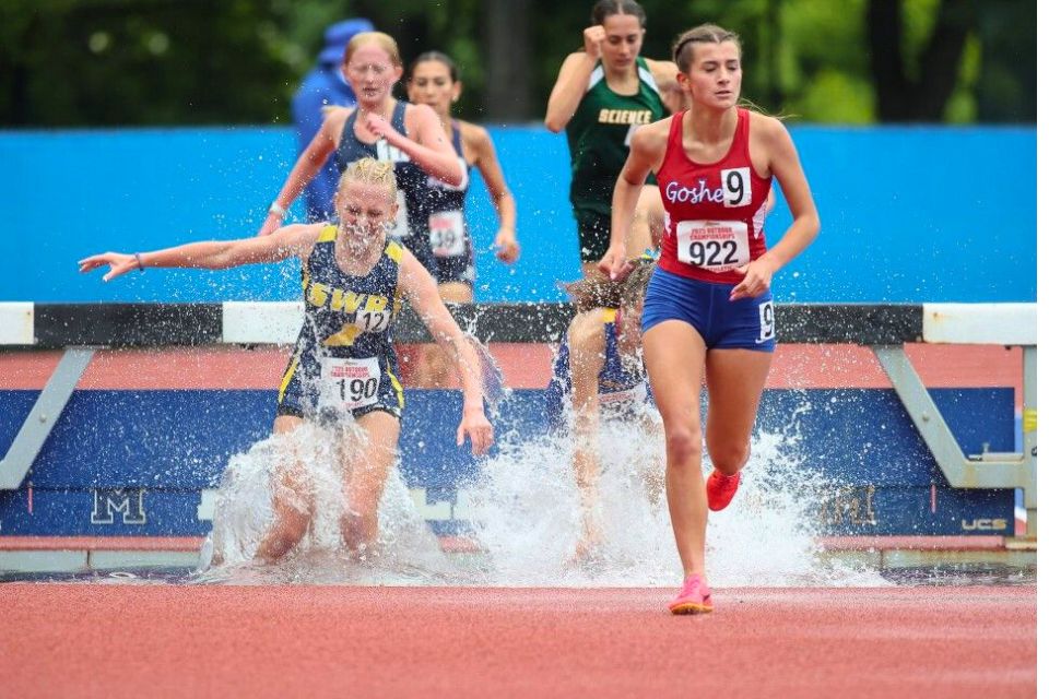 Isabel Barnhorst runs ahead of her competitors at the 2000 meter steeplechase.
