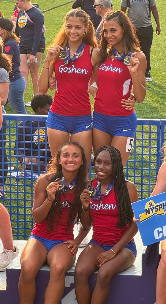 Olivia Sawyer, Joy Sawyer, Daniella Grant and Larianna Bala smile with their medals at the podium at the state championship meet.
