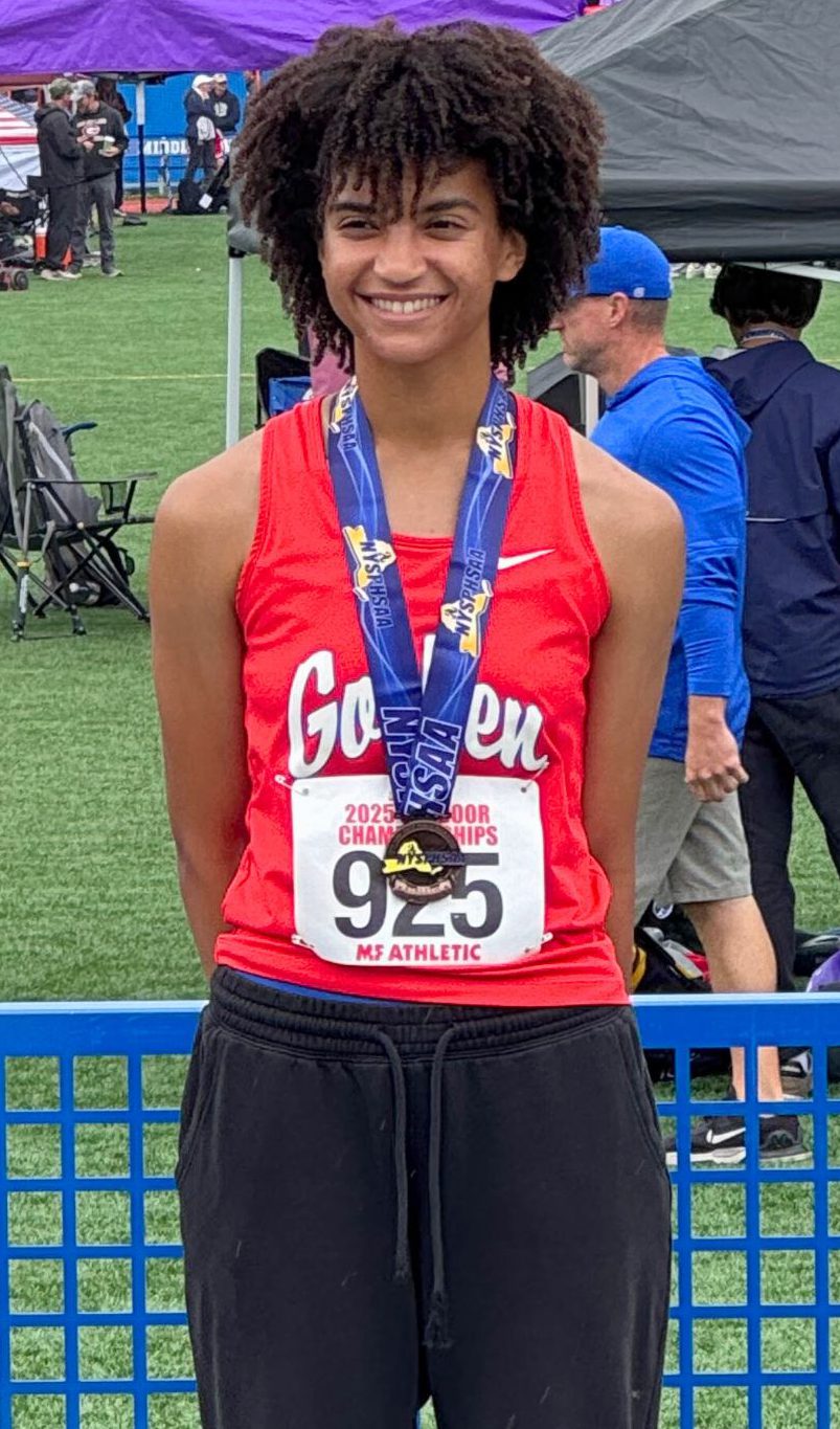 Laila Logan smiles for a photo on the podium with her medal at the New York State championship meet.
