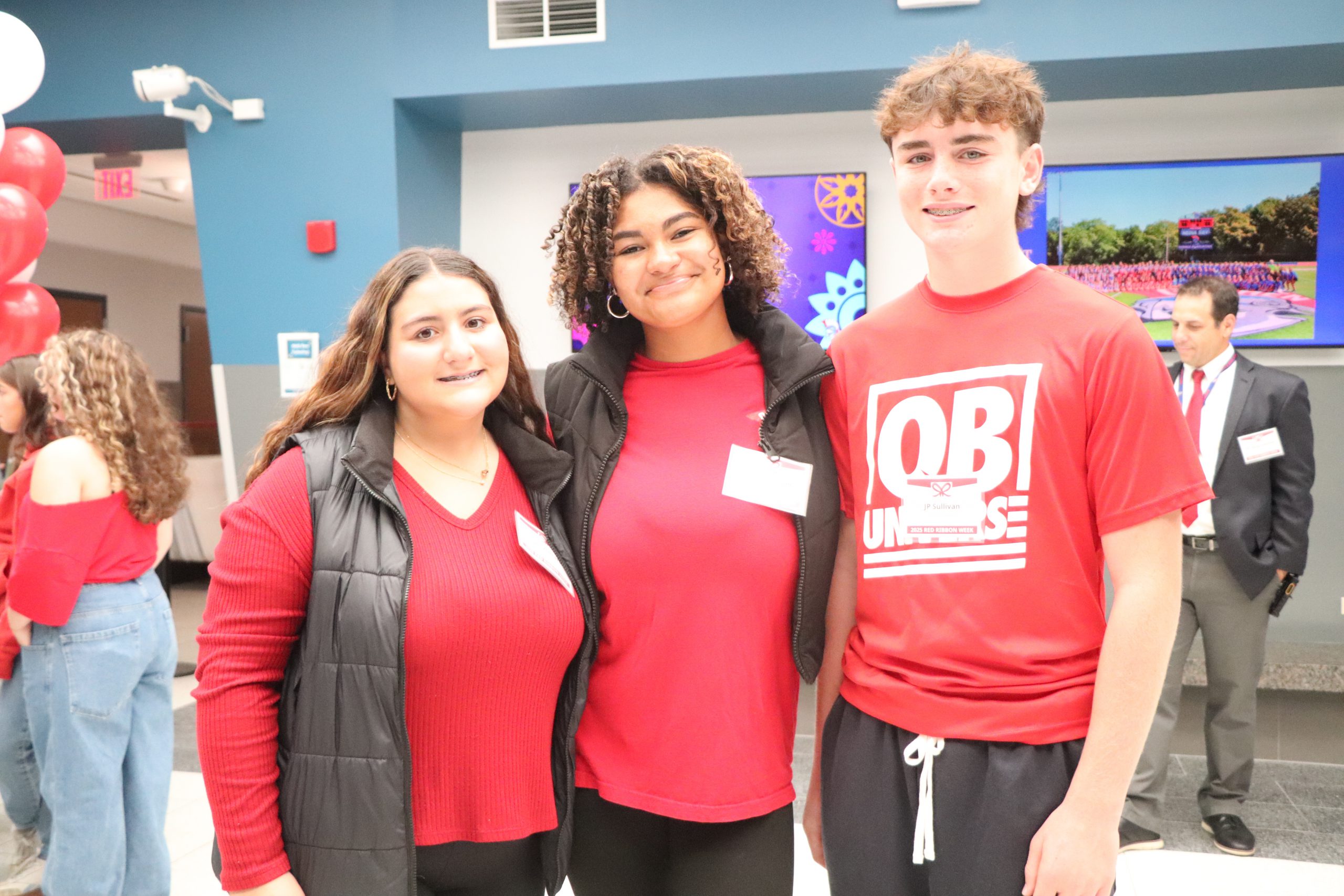 Teens wearing red shirts