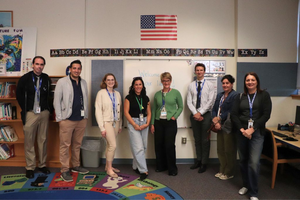 A group of BOCES librarians and Amy Gargiulo pose for a photo in the Scotchtown Avenue Elementary School library. 