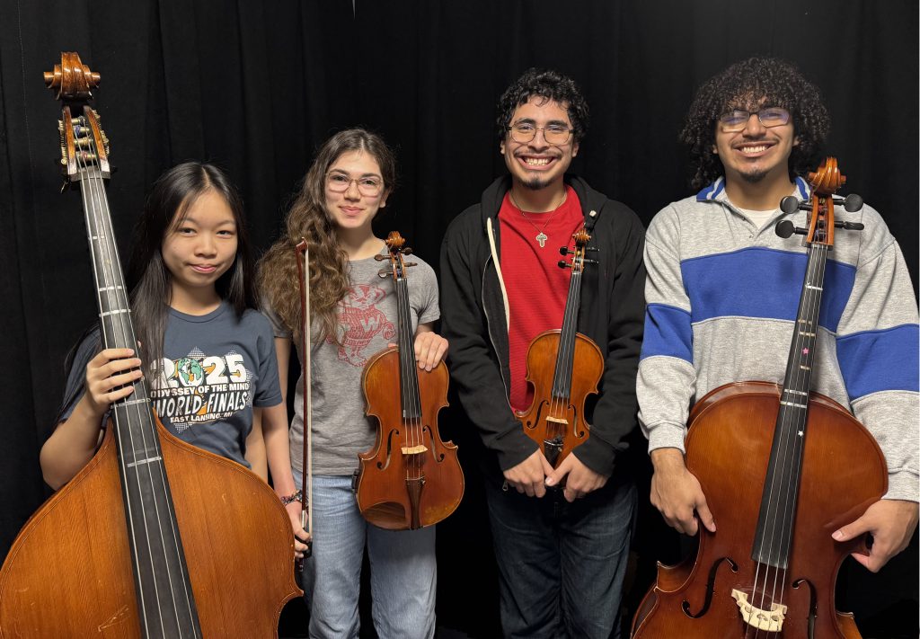 High school students holding orchestra instruments