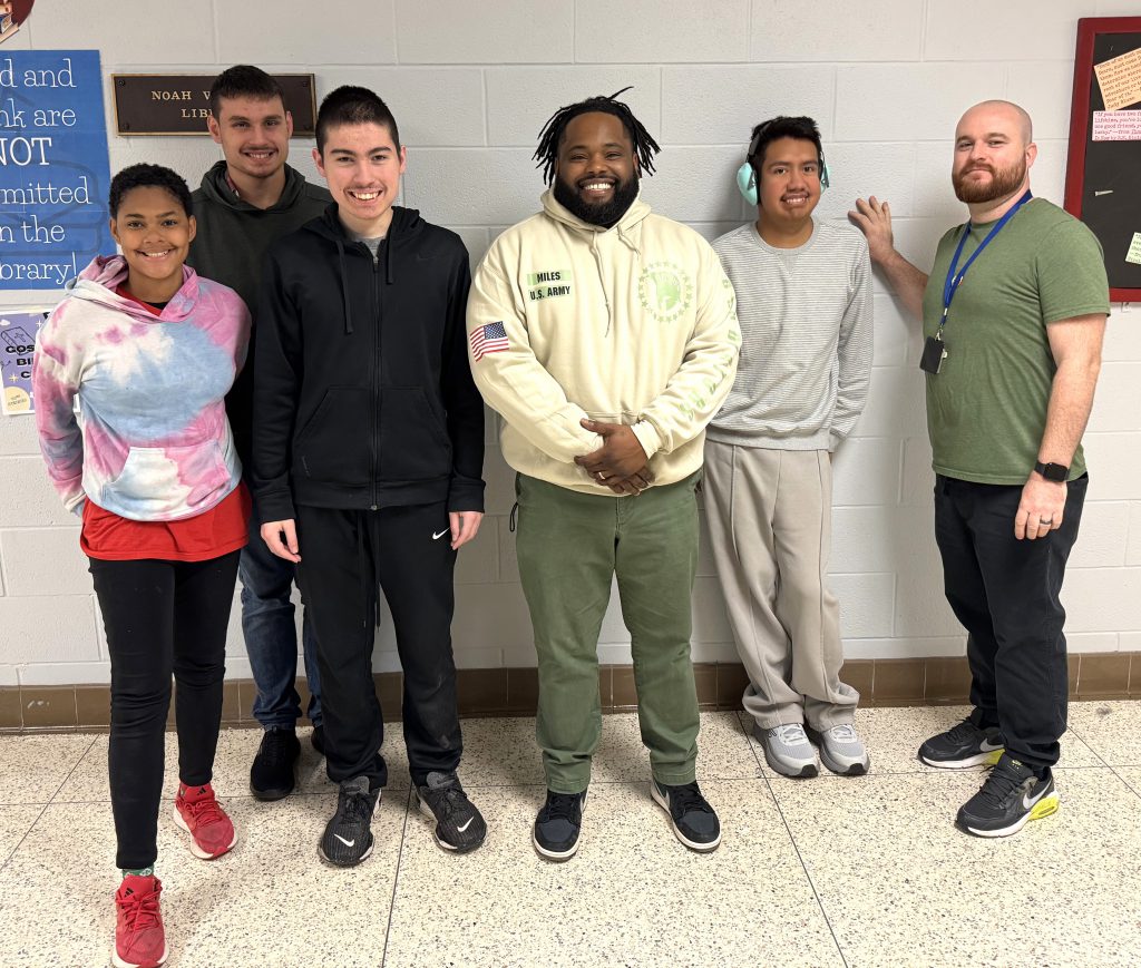 Students surround US Army veteran and teacher Fred Miles