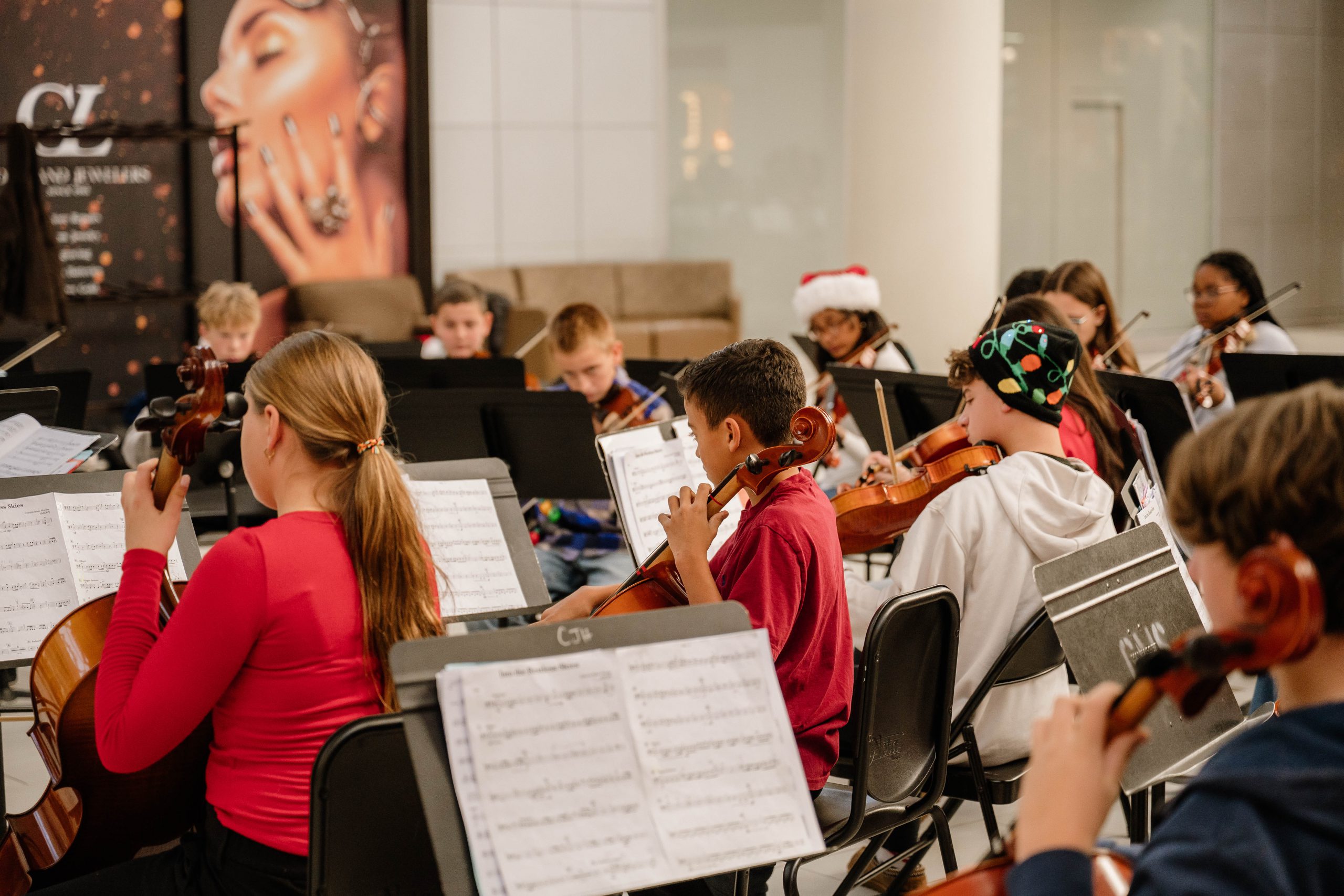 Orchestra students performing at a mall