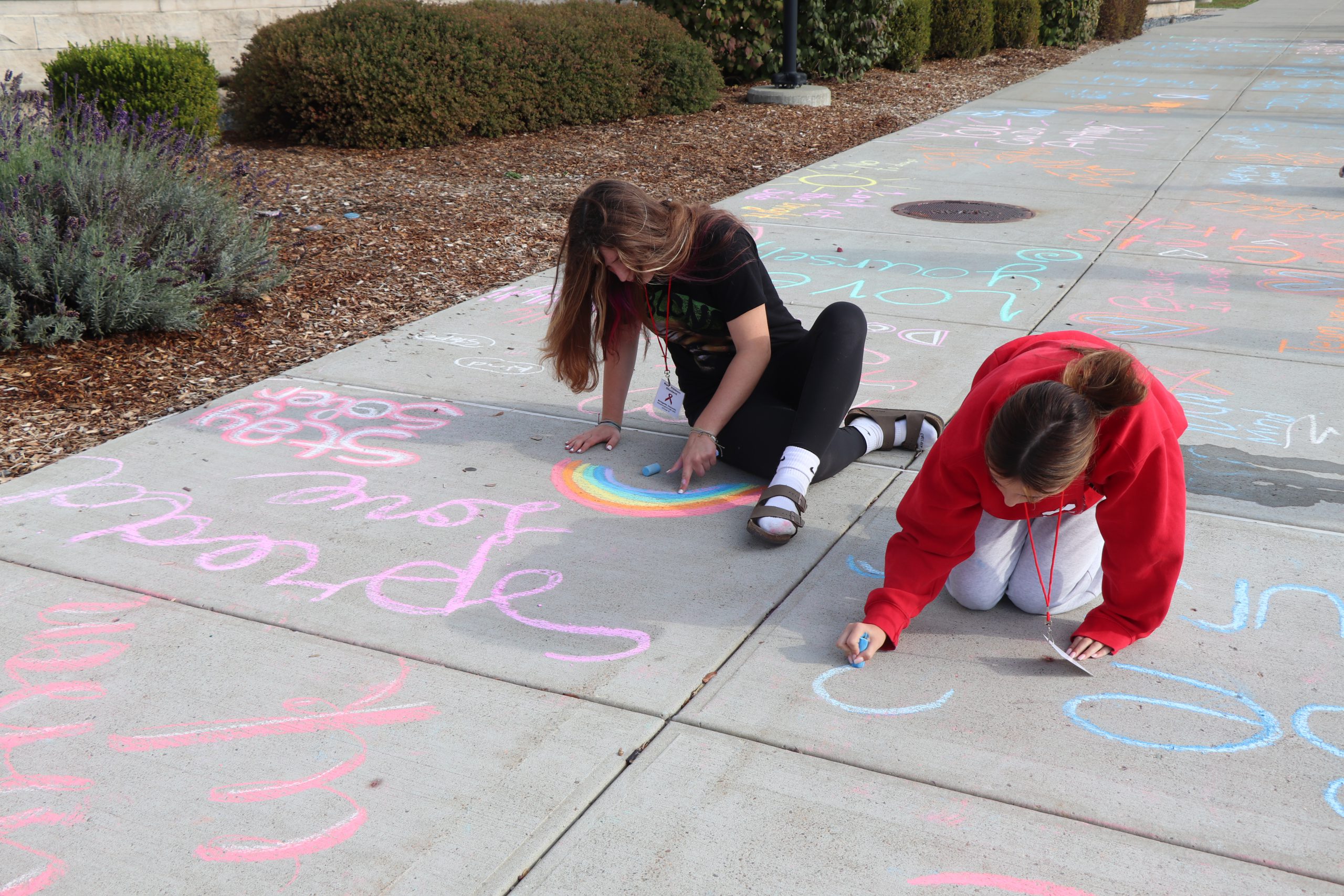 Group of students in front of bulletin board that says Amazing Things Happen Here