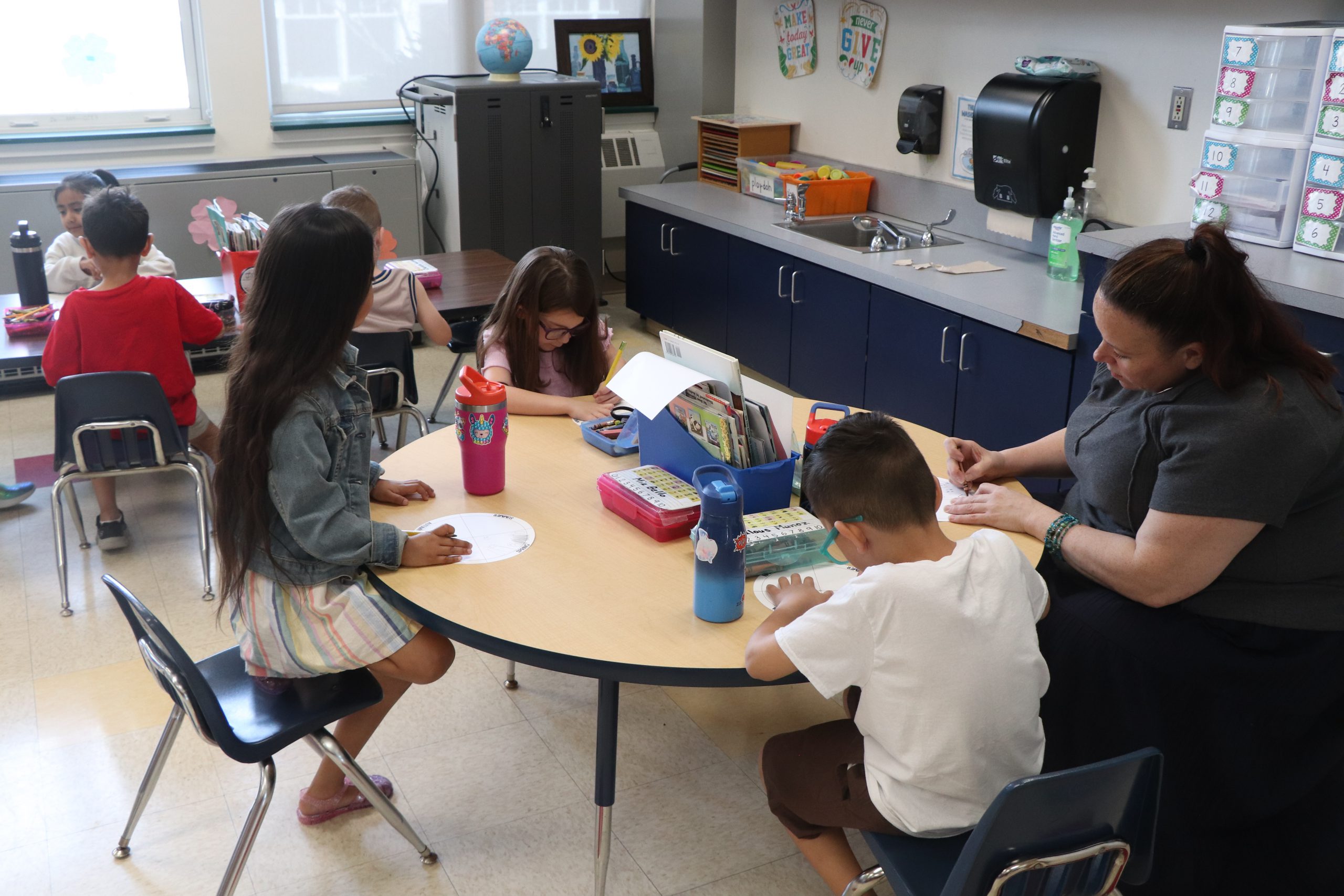 Group of students in front of bulletin board that says Amazing Things Happen Here